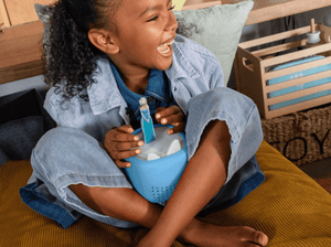 child playing with a frozen tonie and Toniebox Lite Cover Arctic Blue on a toniebox lite