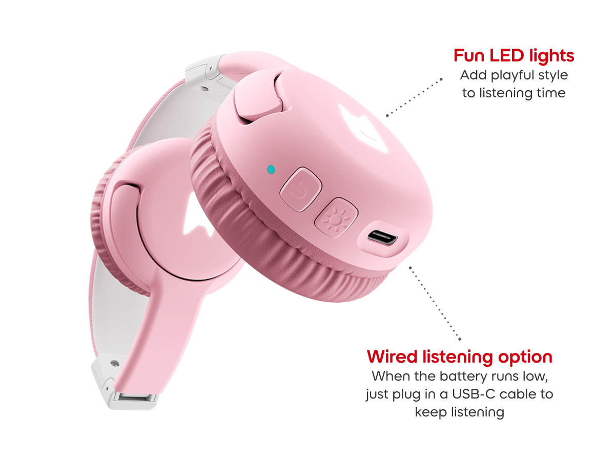 Close-up of ear pad on cloud pink bluetooth headphones for kids, showcasing the USB-C charger and pulsating LEDs light