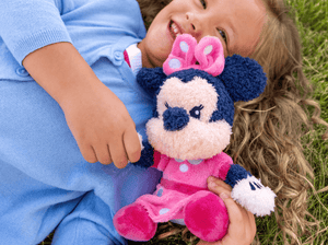 Child playing with minnie mouse cuddle Tonie audio figurine and Toniebox 2