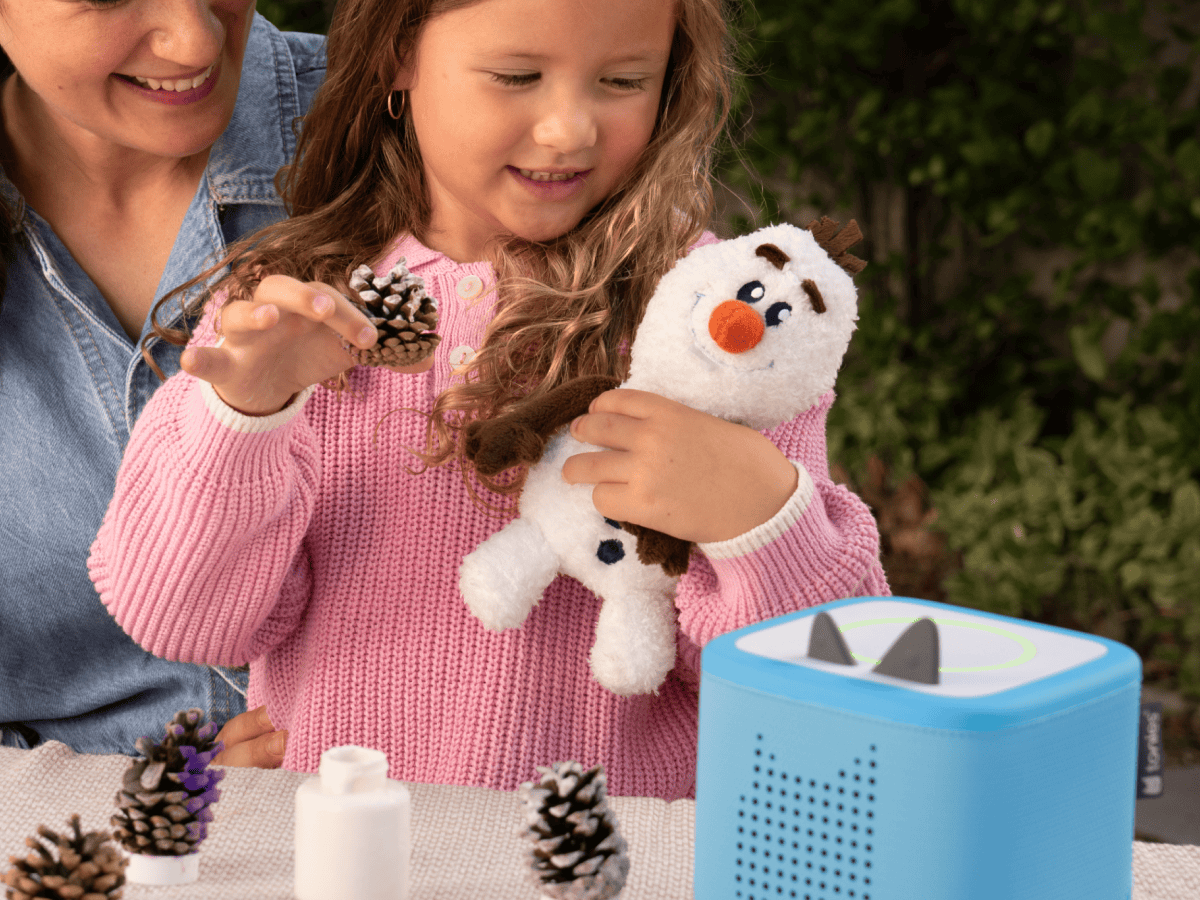 Child playing with olaf cuddle Tonie audio figurine and Toniebox 2