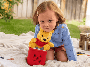 Child playing with Cuddle Tonie- Disney Winnie the Pooh audio figurine and Toniebox 2