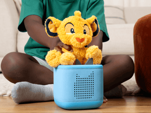 Child playing with Cuddle Tonie- Disney SimbaTonie audio figurine and Toniebox 2