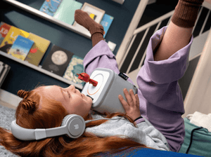Child Listening To The Toniebox 2 And Tonie With Gray Wired Headphones For Kids