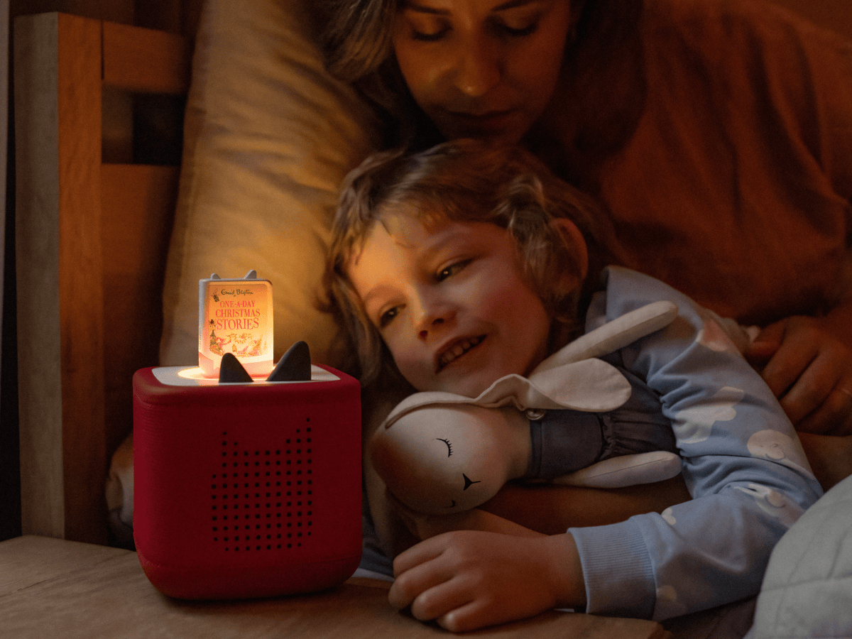 mother and child listening to Enid Blyton One-A-Day Christmas Stories Book Tonie on a red toniebox 2