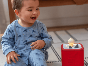 Child Playing With Sleepy Duck Audio Figurine And Toniebox 2