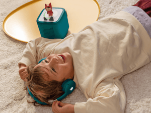 Child Listening To The Toniebox 2 And Tonie With Teal Bluetooth Headphones For Kids